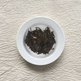 Pasha Ancient Tree Ripe Pu-erh on a plate