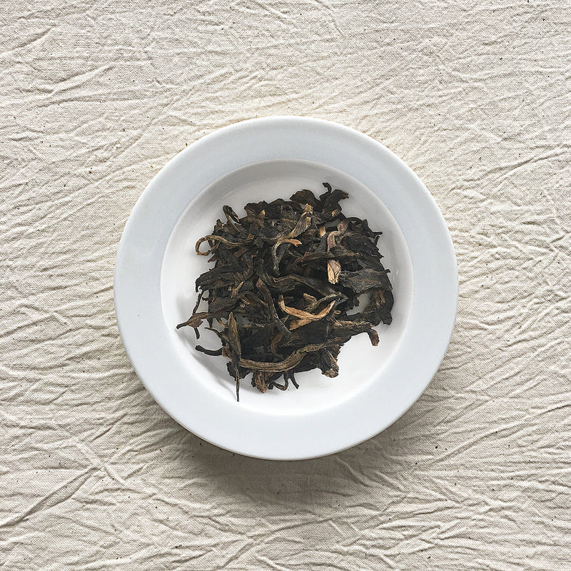 Mansa Tea | Amber Pu'er | Bangwei Ancient Tree Raw Pu'er | high quality aged pu'er or pu-erh tea, a type of post-fermented tea from Yunnan province, with aging potential of 40-60 years - image of aged pu'er or aged pu-er on a plate