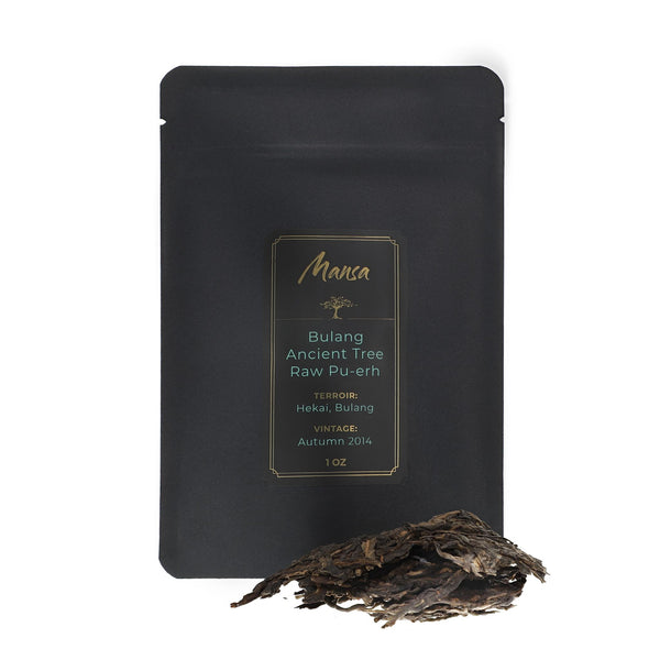 Bulang Ancient Tree Raw Pu-erh front packaging photo. A black pouch with a label with a piece of broken tea cake