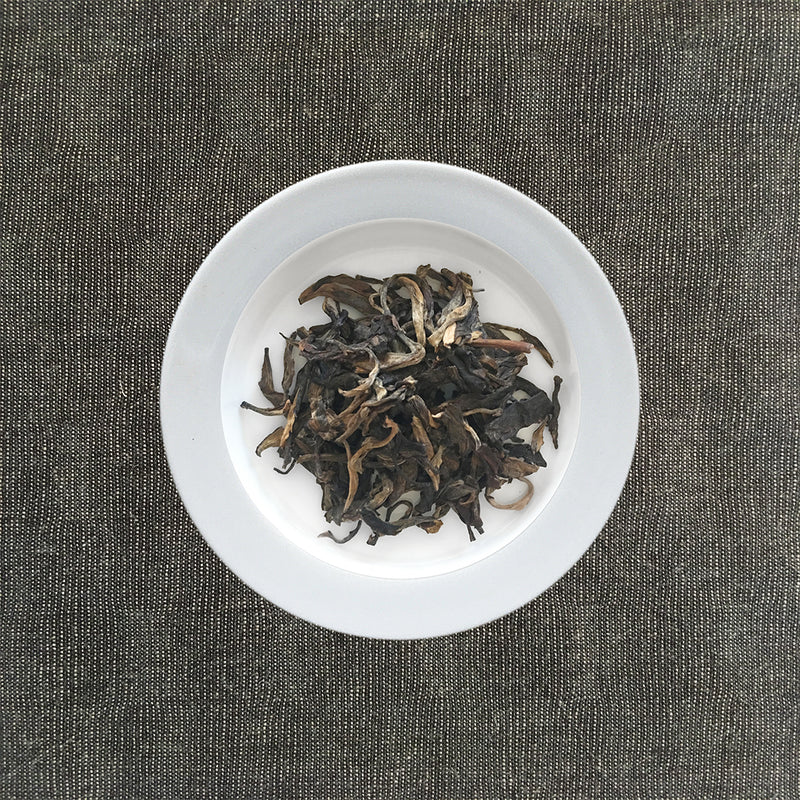 Mansa Tea | Amber Pu'er | Banzhang Raw Pu'er | high quality aged pu'er or pu-erh tea, a type of post-fermented tea from Yunnan province, with aging potential of 40-60 years - image of aged pu'er or aged pu-erh tea on a plate