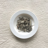 Mansa Tea | Pearl White | Fuding White Peony | high quality aged white tea from Fujian province - image of aged white tea on a plate