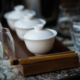 White porcelain gaiwan along with other teaware
